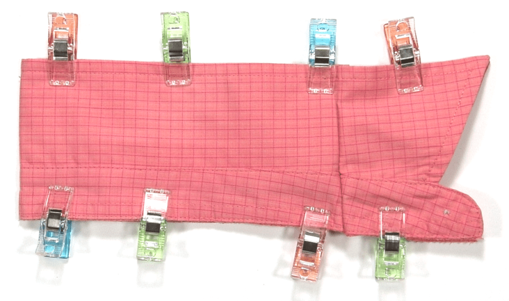 pink shirt collar folded in half secured with sewing clips