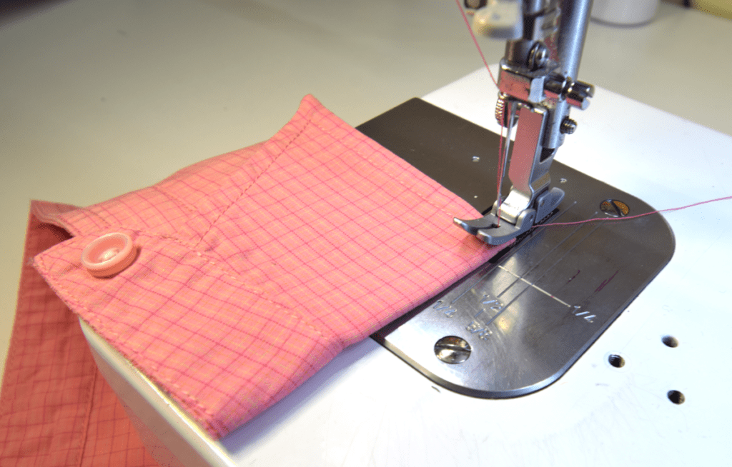 pink shirt collar on a sewing machine