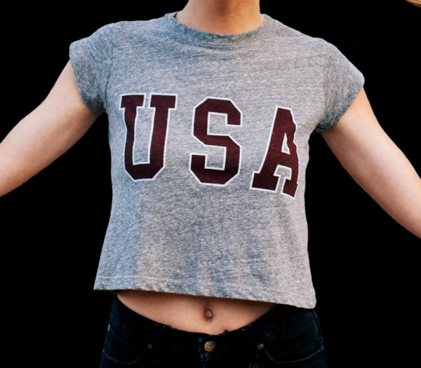 girl in a short USA shirt