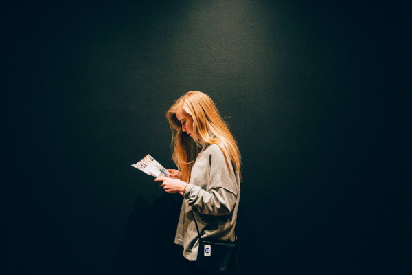 girl reading a paper